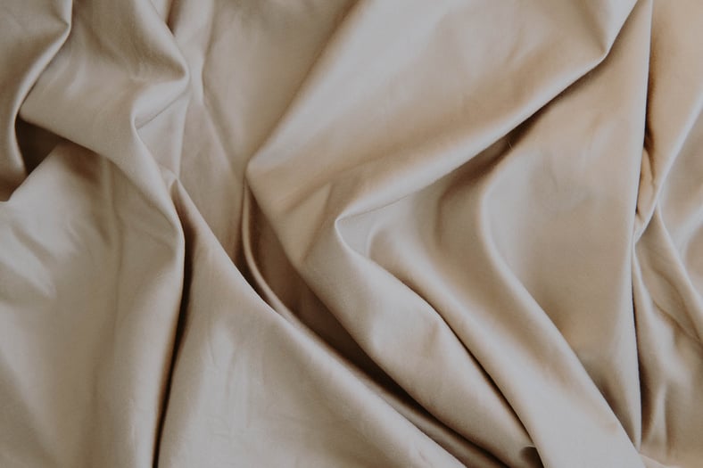 White Textile on Brown Wooden Table